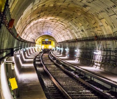 Dramatic view of a Berlin subway tunnel with train approaching, showcasing modern infrastructure.